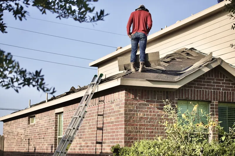 Professional roofer working on a residential roof in South Meriden